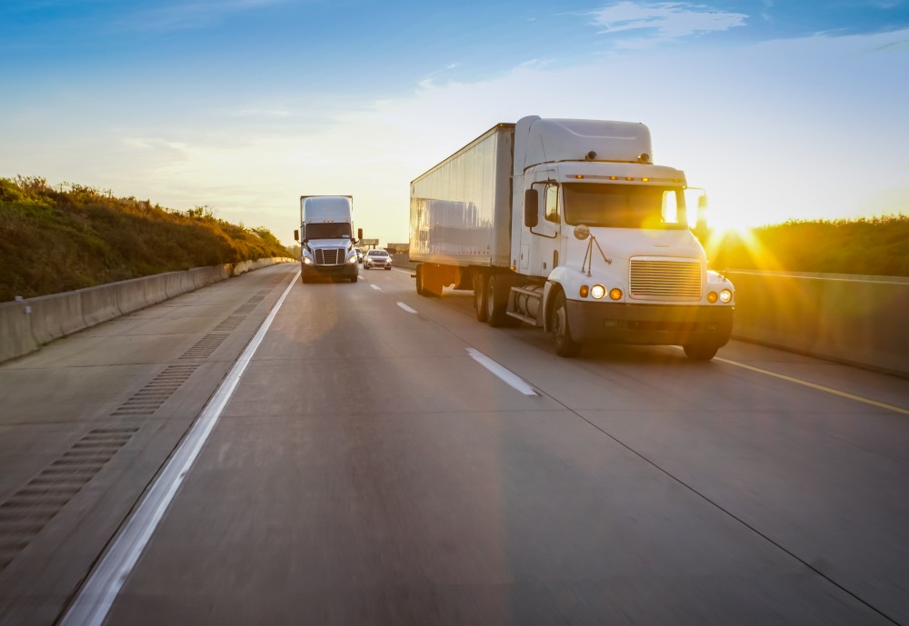 semi trucks driving down a highway